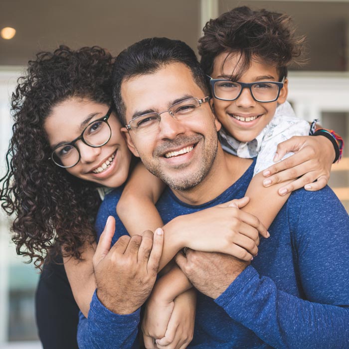 smiling family of three