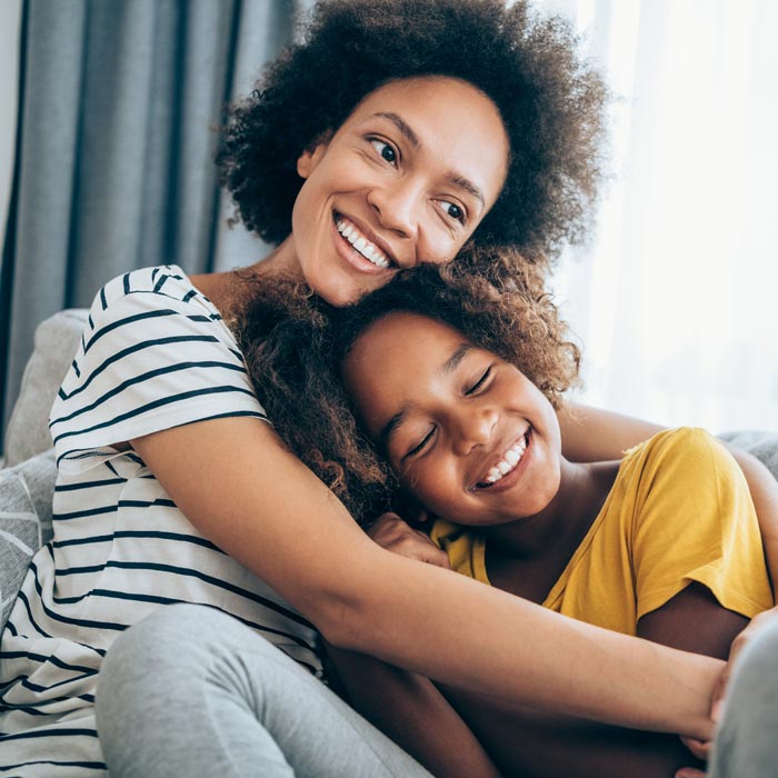 smiling mother and young daughter