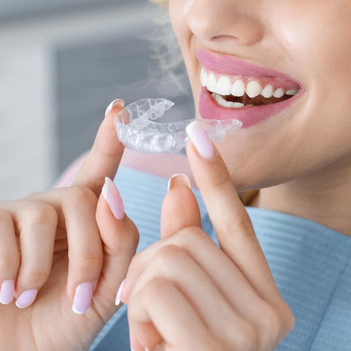 woman with clear aligners