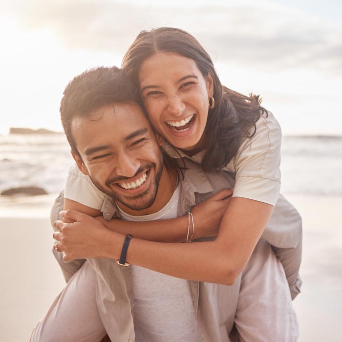 laughing young couple on beach