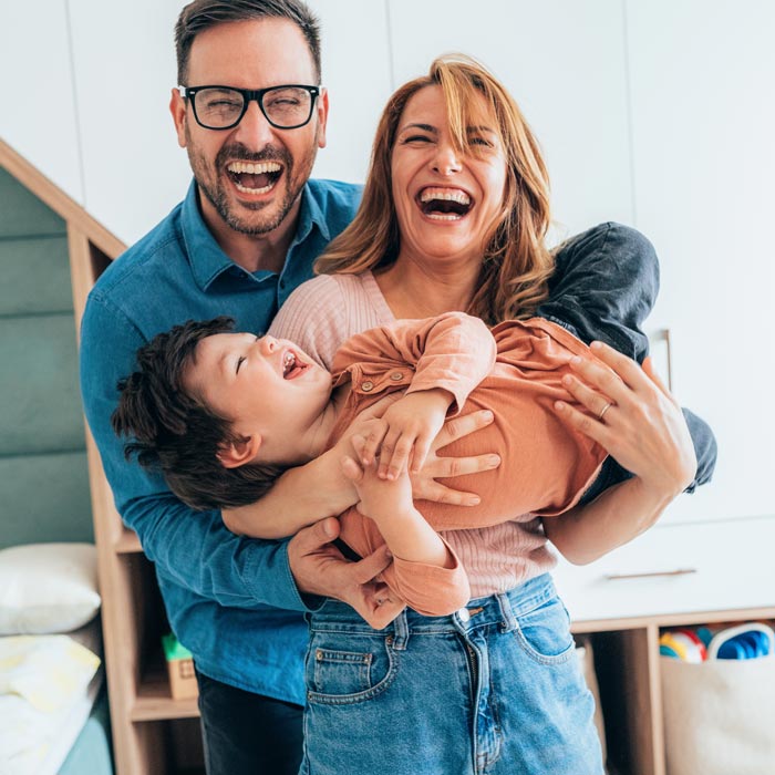 laughing family of three